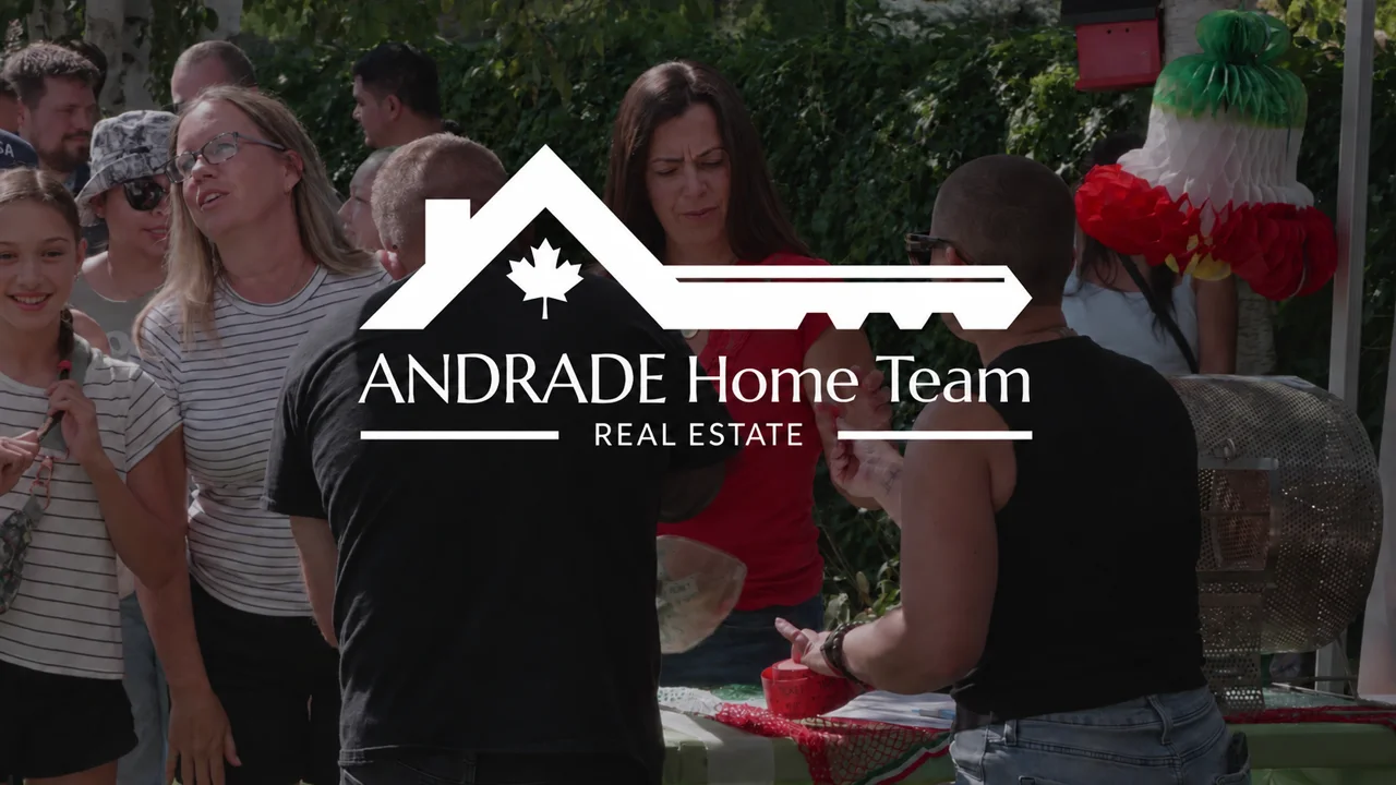 Andrade Home Team white logo over guests at our client appreciation fiesta